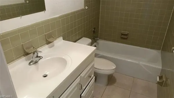 a bathroom with a sink a toilet and bathtub
