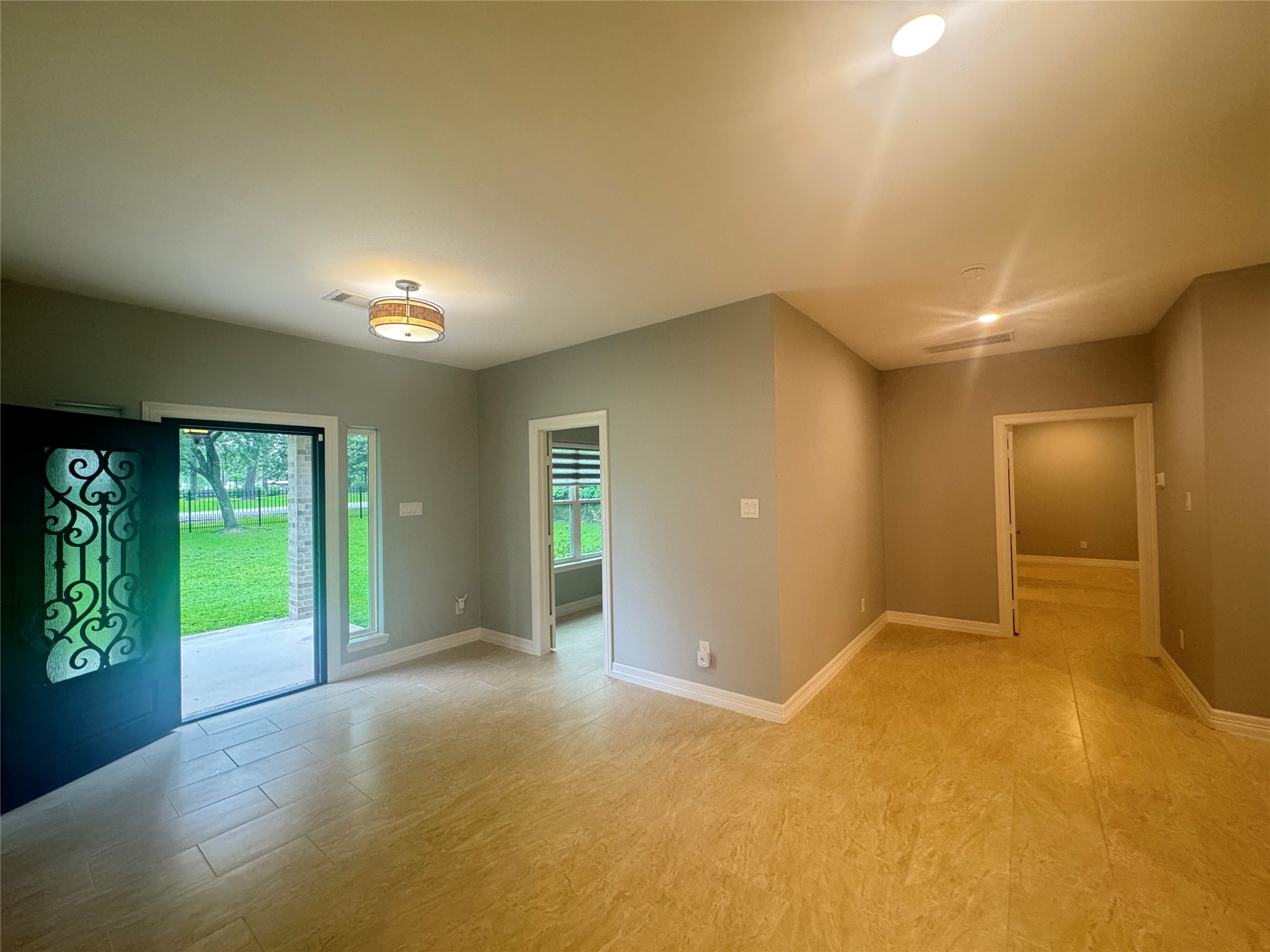 2010 Cherry Laurel Spring, TX 77386 - Photo 7 of 45 Reverse view of entrance with study room in middle, primary bedroom and hallway to the right