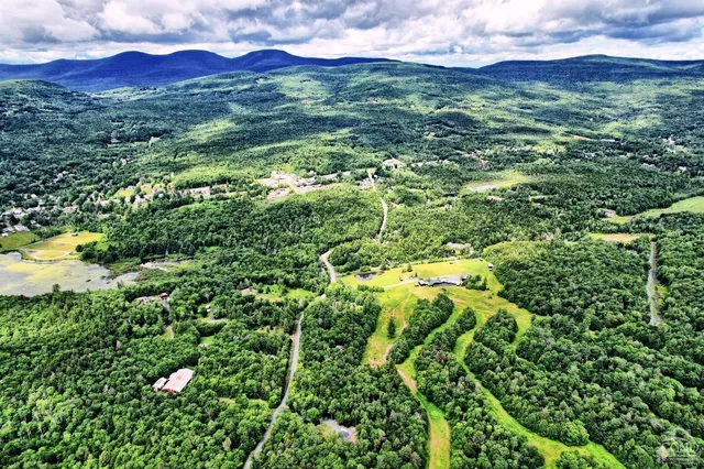 an aerial view of residential house with an outdoor space and seating