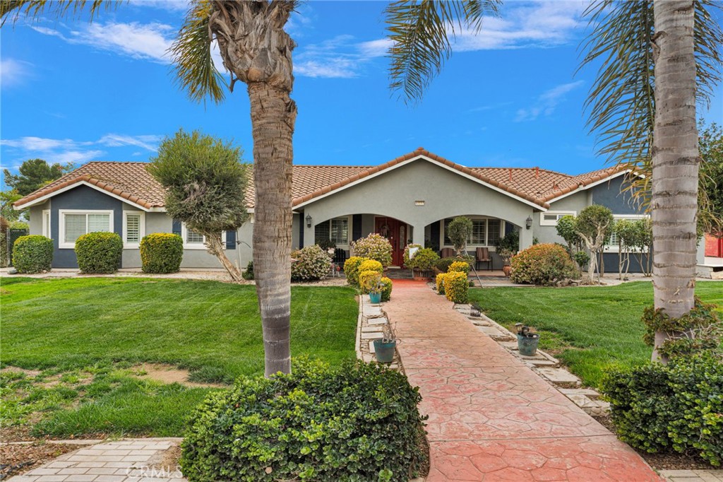 17777 Brazier Drive Riverside, CA 92508 - Photo 1 of 55 a front view of a house with a garden and yard