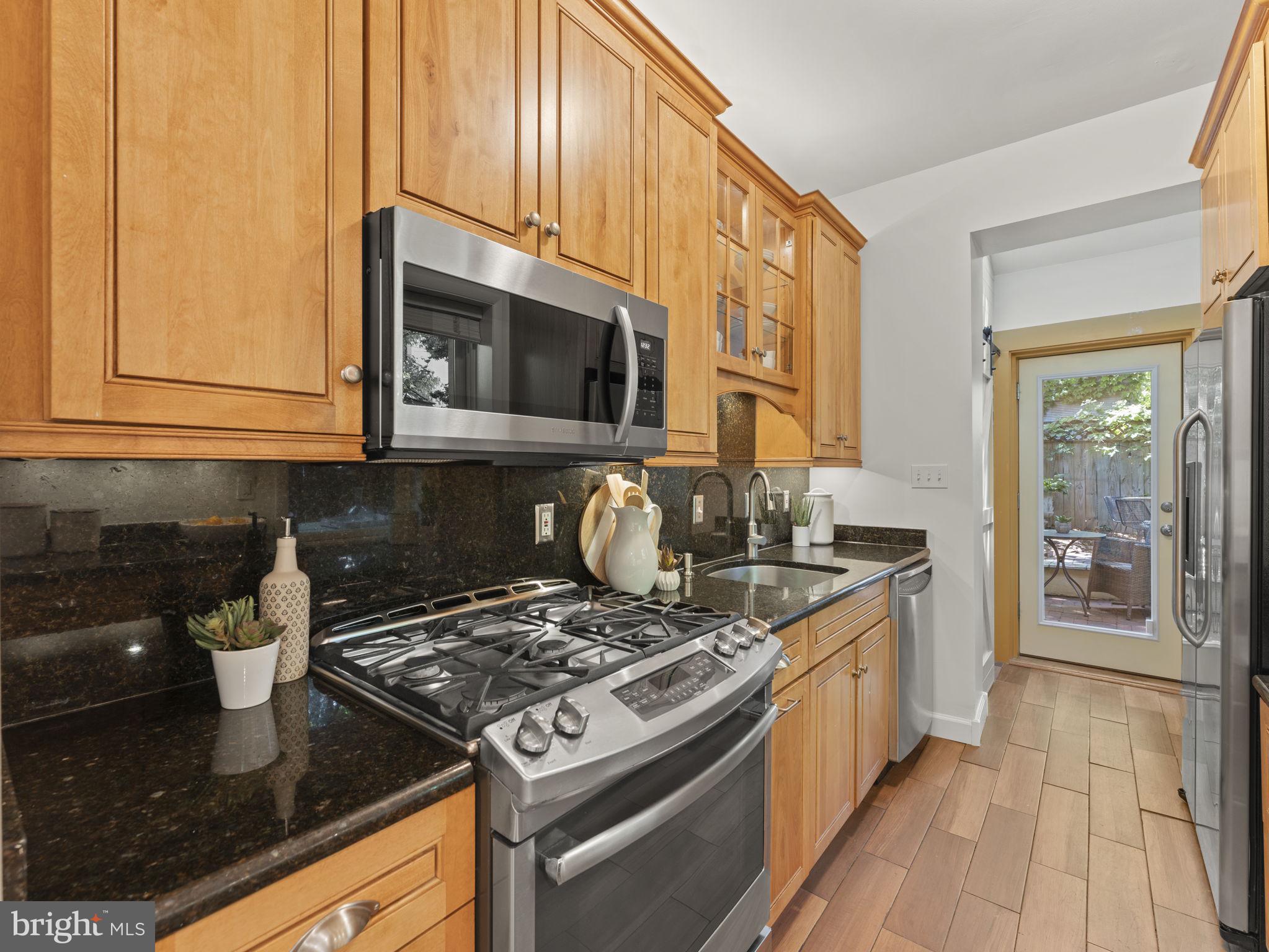 407 5th Street Northeast Washington, DC 20002 - Photo 12 of 41 a kitchen with stainless steel appliances granite countertop a stove a microwave and a sink