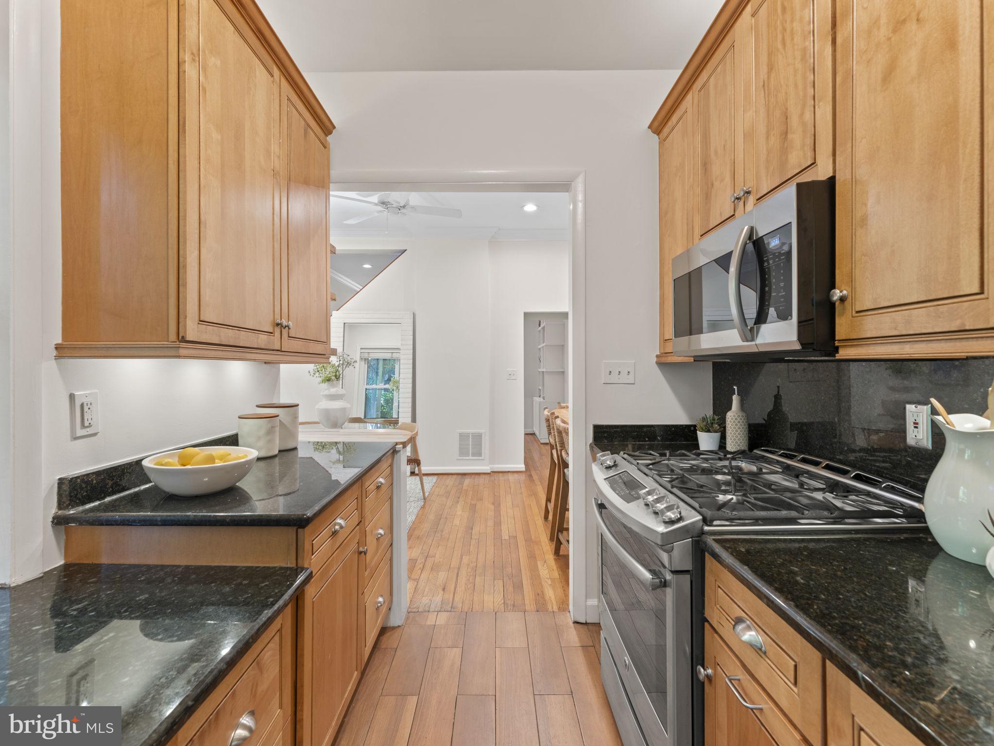 407 5th Street Northeast Washington, DC 20002 - Photo 14 of 41 a kitchen with stainless steel appliances granite countertop a stove a sink and a microwave