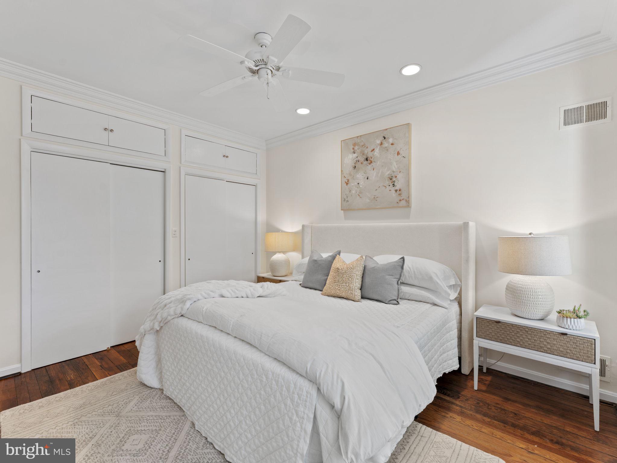 407 5th Street Northeast Washington, DC 20002 - Photo 19 of 41 a spacious bedroom with a bed and a lamp