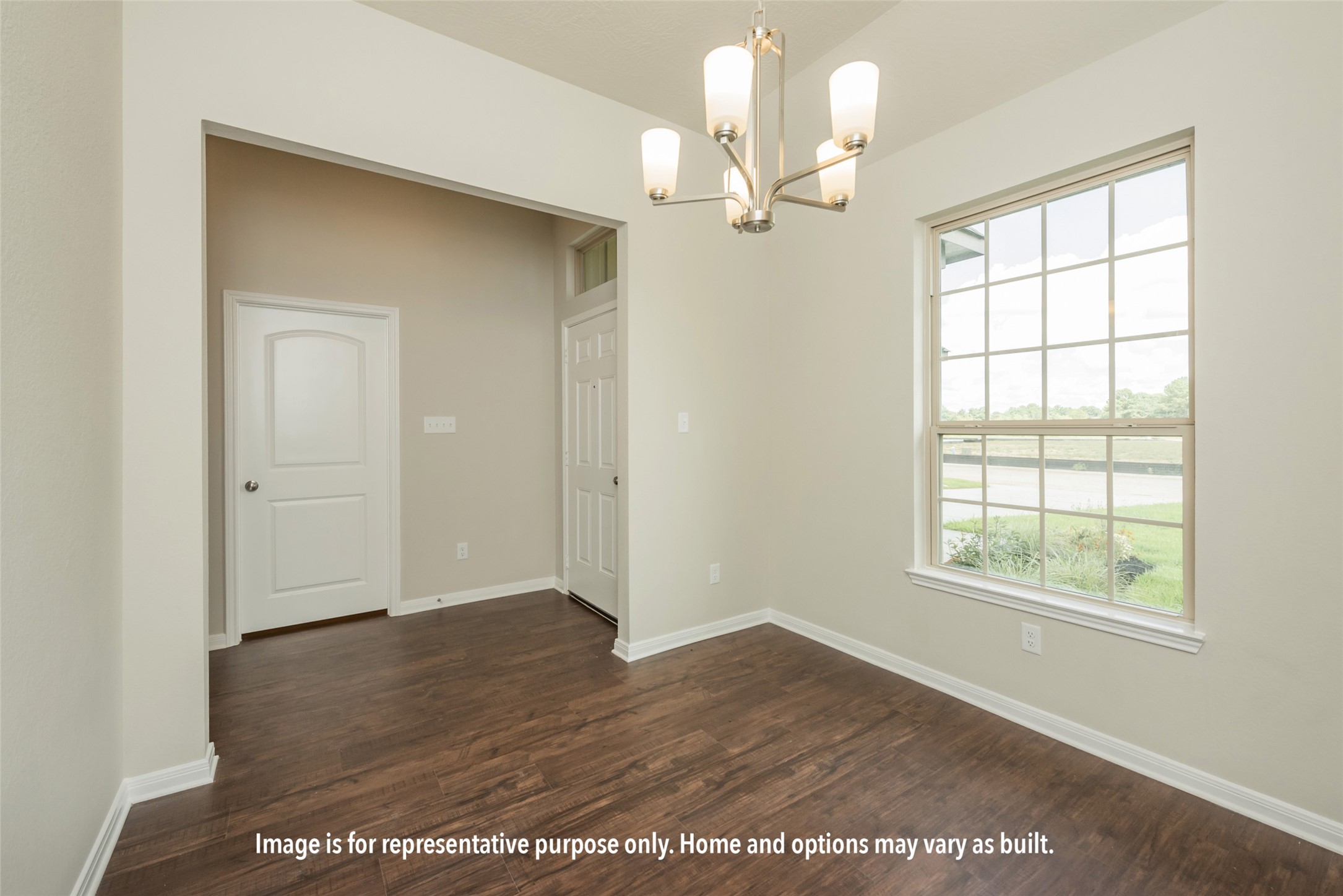 1498 Lk Rdg Drive Brenham, TX 77833 - Photo 12 of 15 an empty room with wooden floor chandelier and windows