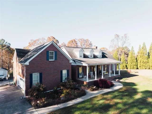a view of house with yard and entertaining space