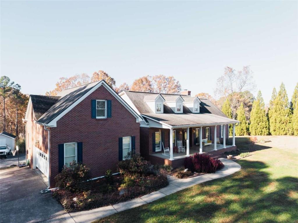 a view of house with yard and entertaining space