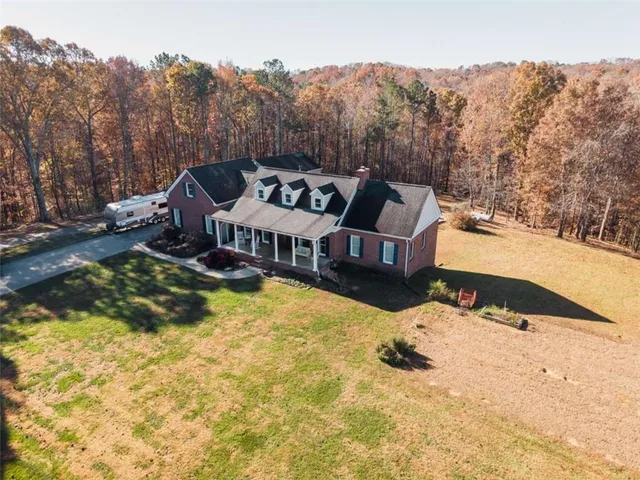 a view of a house with a yard covered in snow