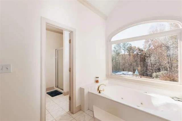 a bathroom with a tub sink and mirror