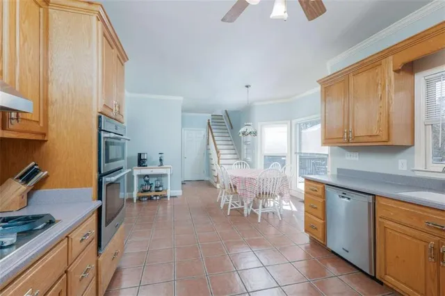 a kitchen with stainless steel appliances granite countertop a refrigerator and a sink