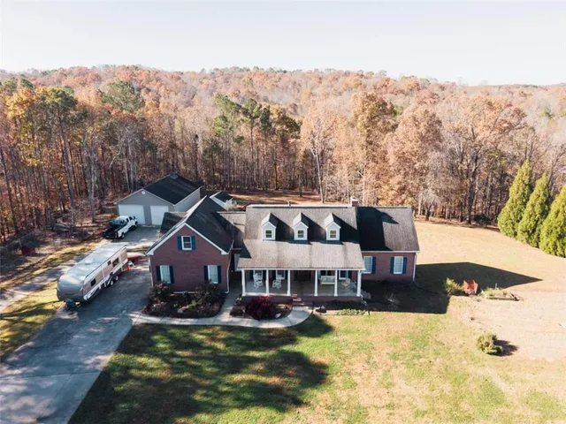 a view of a house with swimming pool and a yard