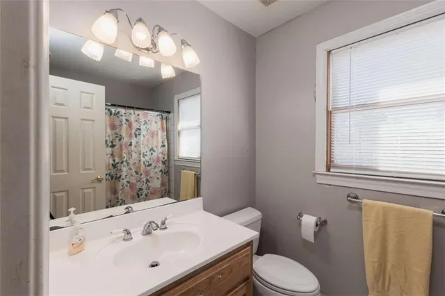 a spacious bedroom with a bed and a window