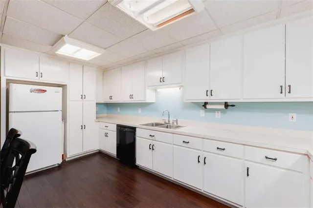 a view of a livingroom with furniture wooden floor windows and a chandelier