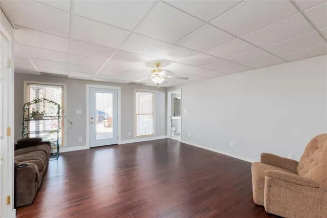 an empty room with wooden floor and window