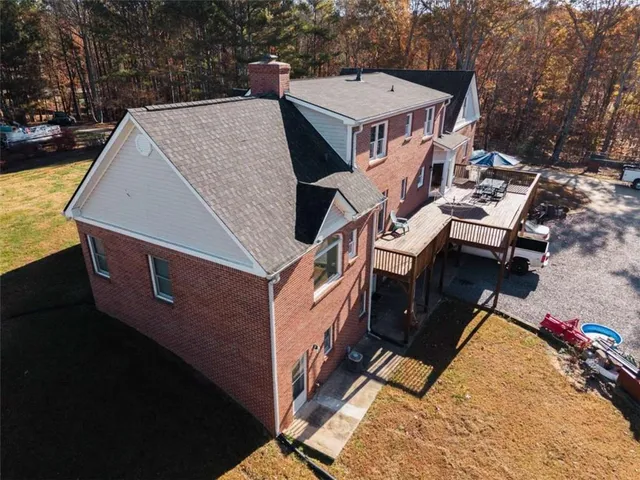 an aerial view of a house with a big yard