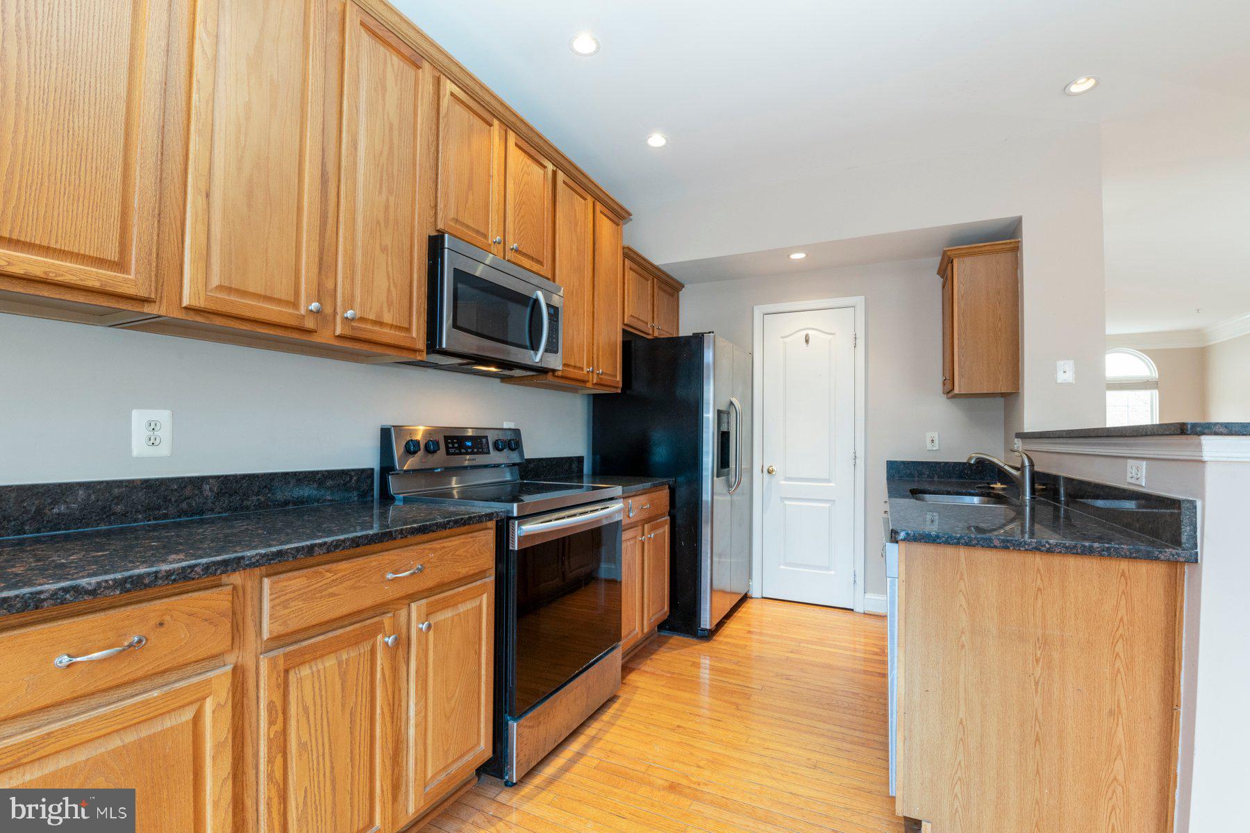 12802 Brightwell Drive Clarksburg, MD 20871 - Photo 4 of 30 a kitchen with stainless steel appliances granite countertop a stove a sink and a granite counter top space