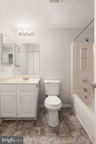 a bathroom with a sink toilet vanity and bathtub