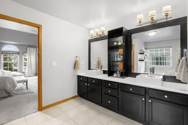 a bathroom with a tub sink and a mirror