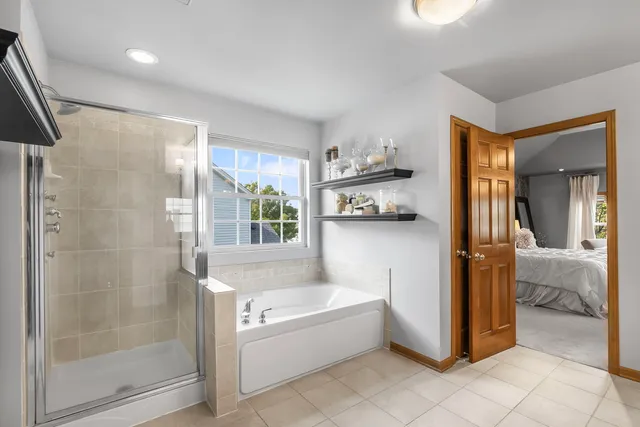 a spacious bathroom with a double vanity sink and a mirror