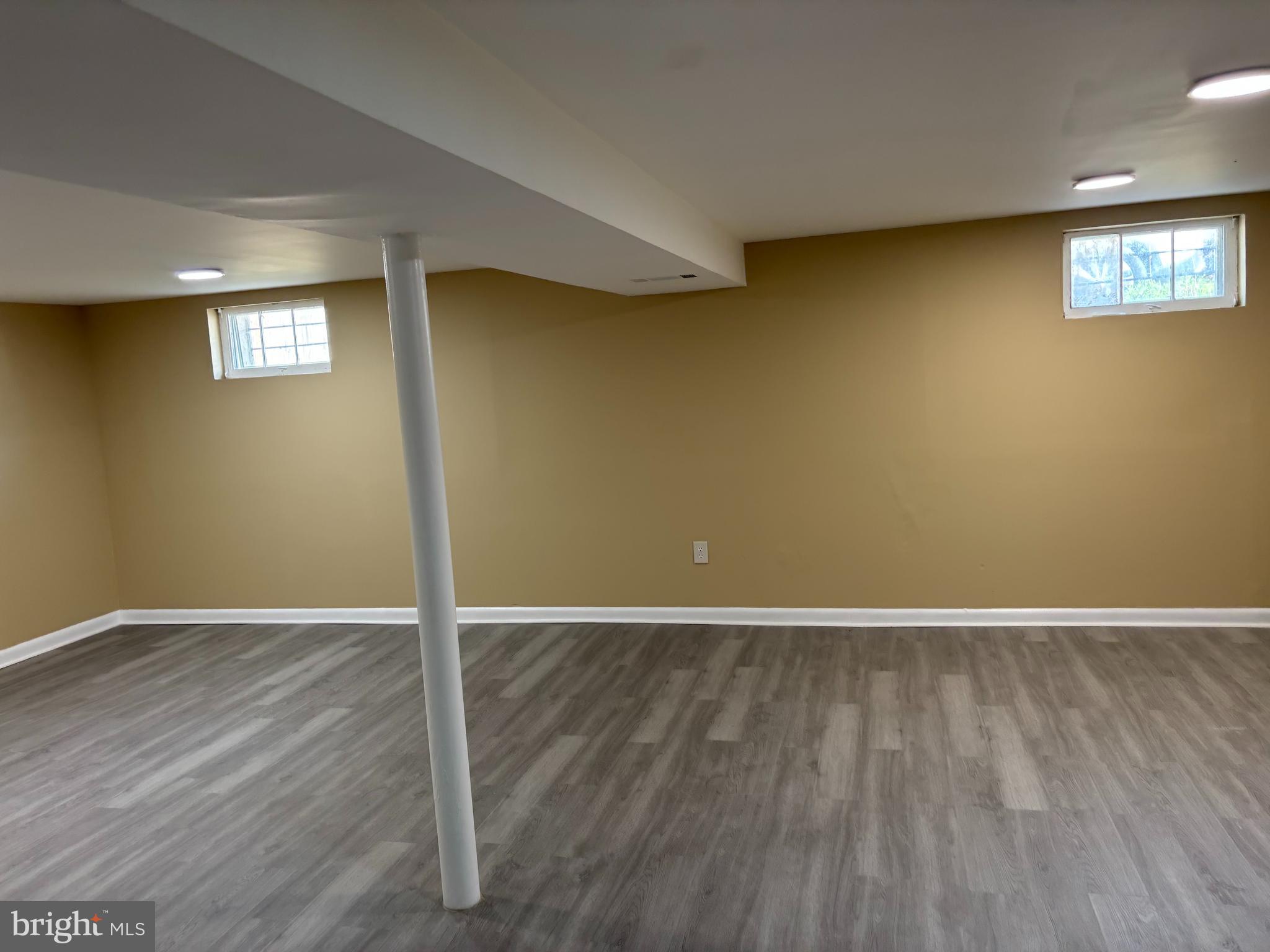 9016 Samoset Road Randallstown, MD 21133 - Photo 12 of 36 an empty room with wooden floor and windows