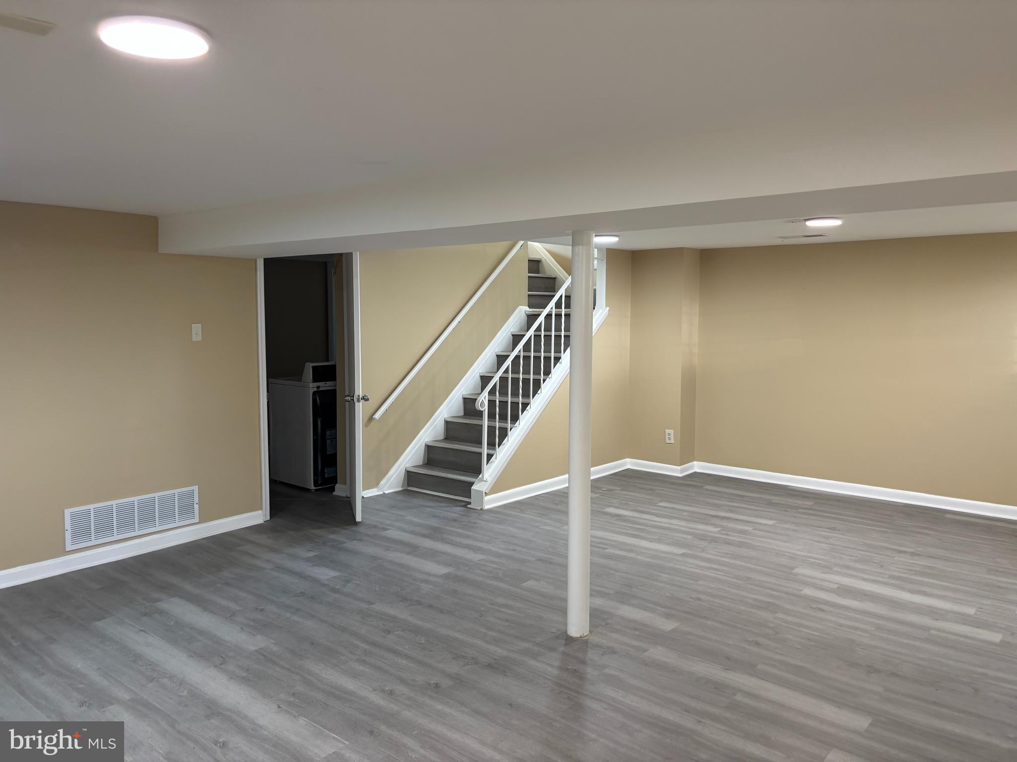 9016 Samoset Road Randallstown, MD 21133 - Photo 13 of 36 a view of an empty room with wooden floor