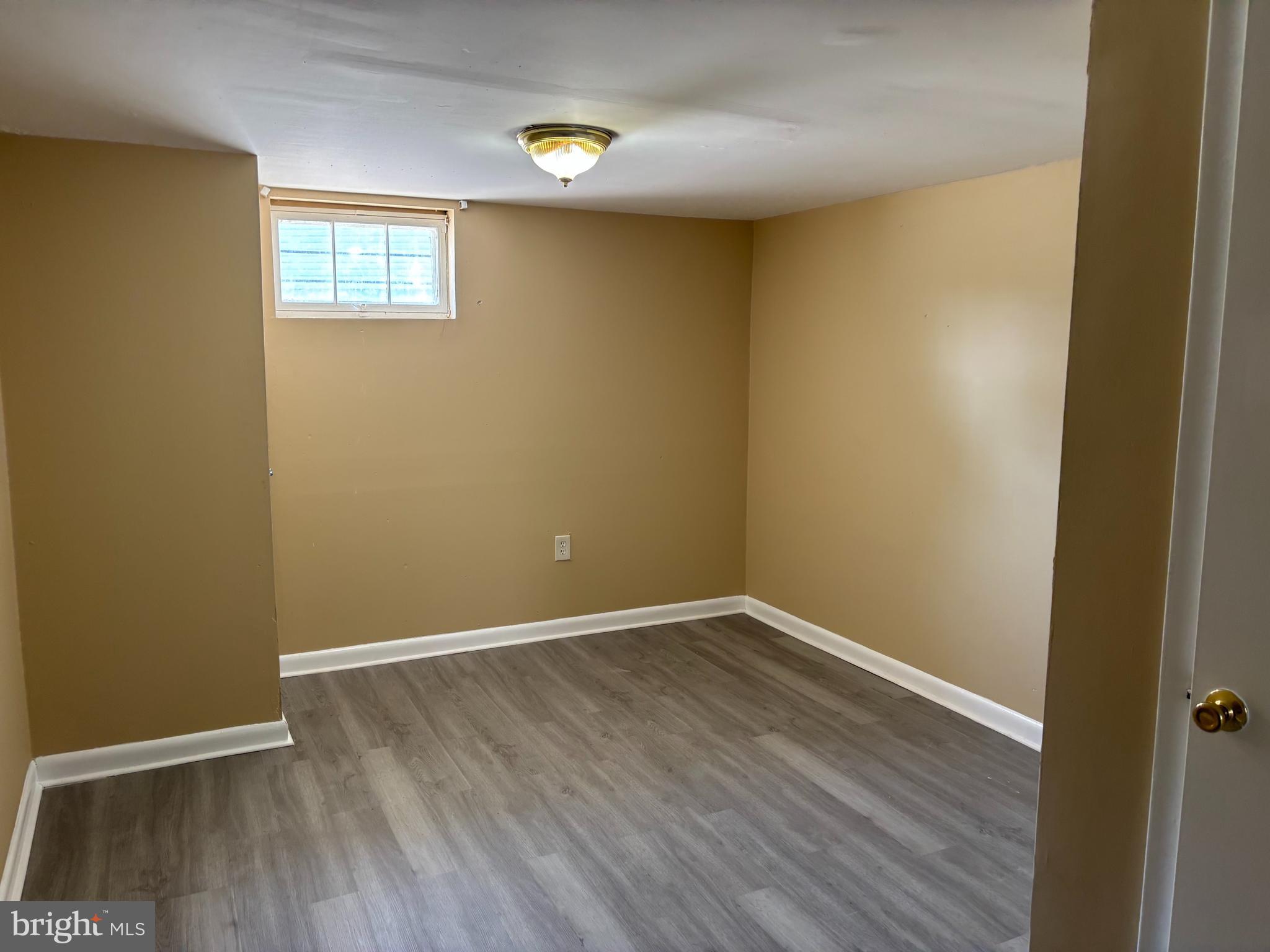 9016 Samoset Road Randallstown, MD 21133 - Photo 15 of 36 a view of an empty room with wooden floor and a window