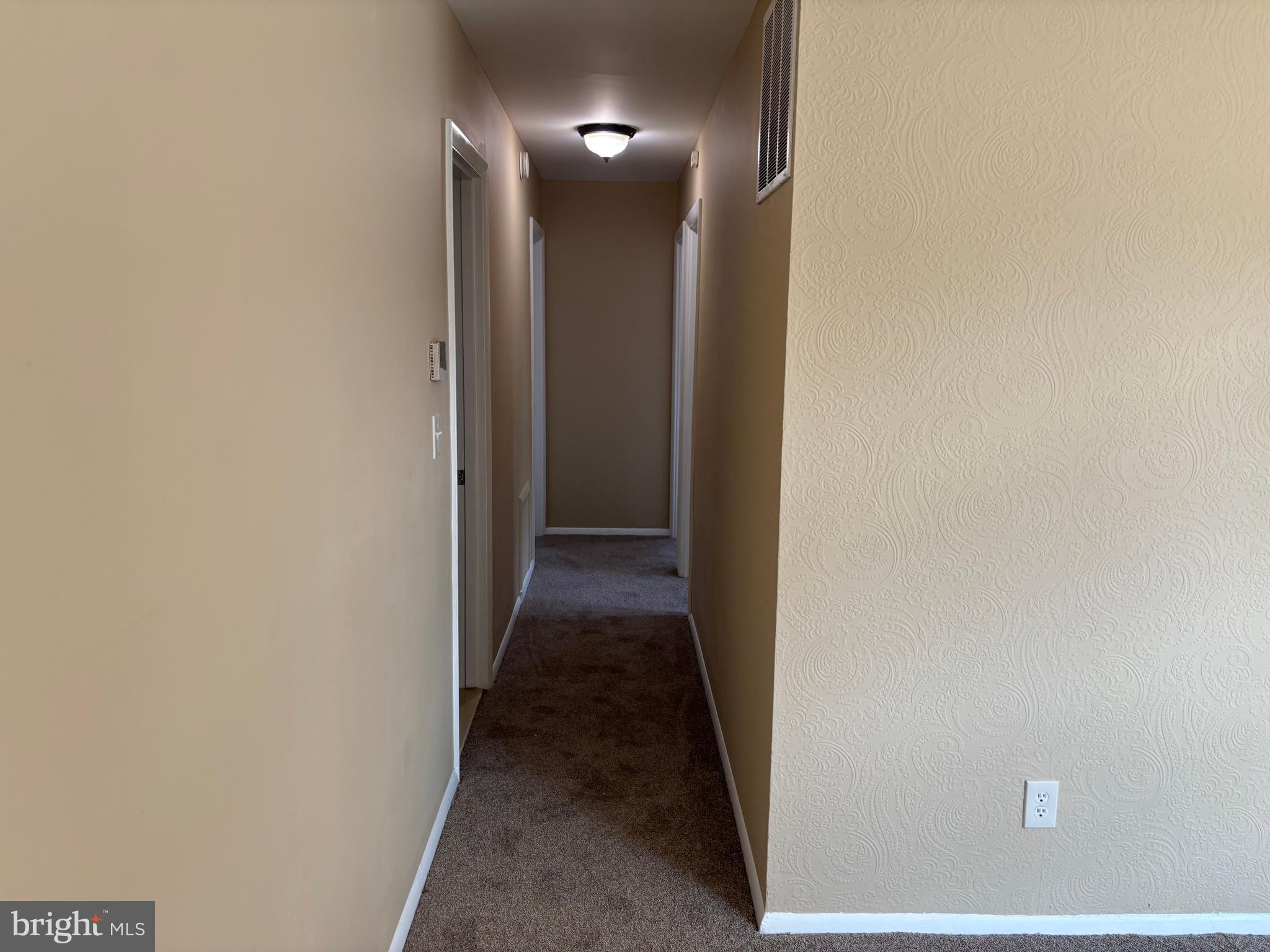 9016 Samoset Road Randallstown, MD 21133 - Photo 23 of 36 a view of a hallway with wooden floor