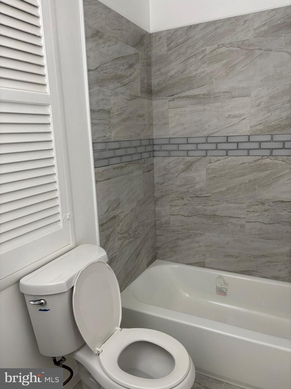 9016 Samoset Road Randallstown, MD 21133 - Photo 27 of 36 a bathroom with a toilet and a bathtub