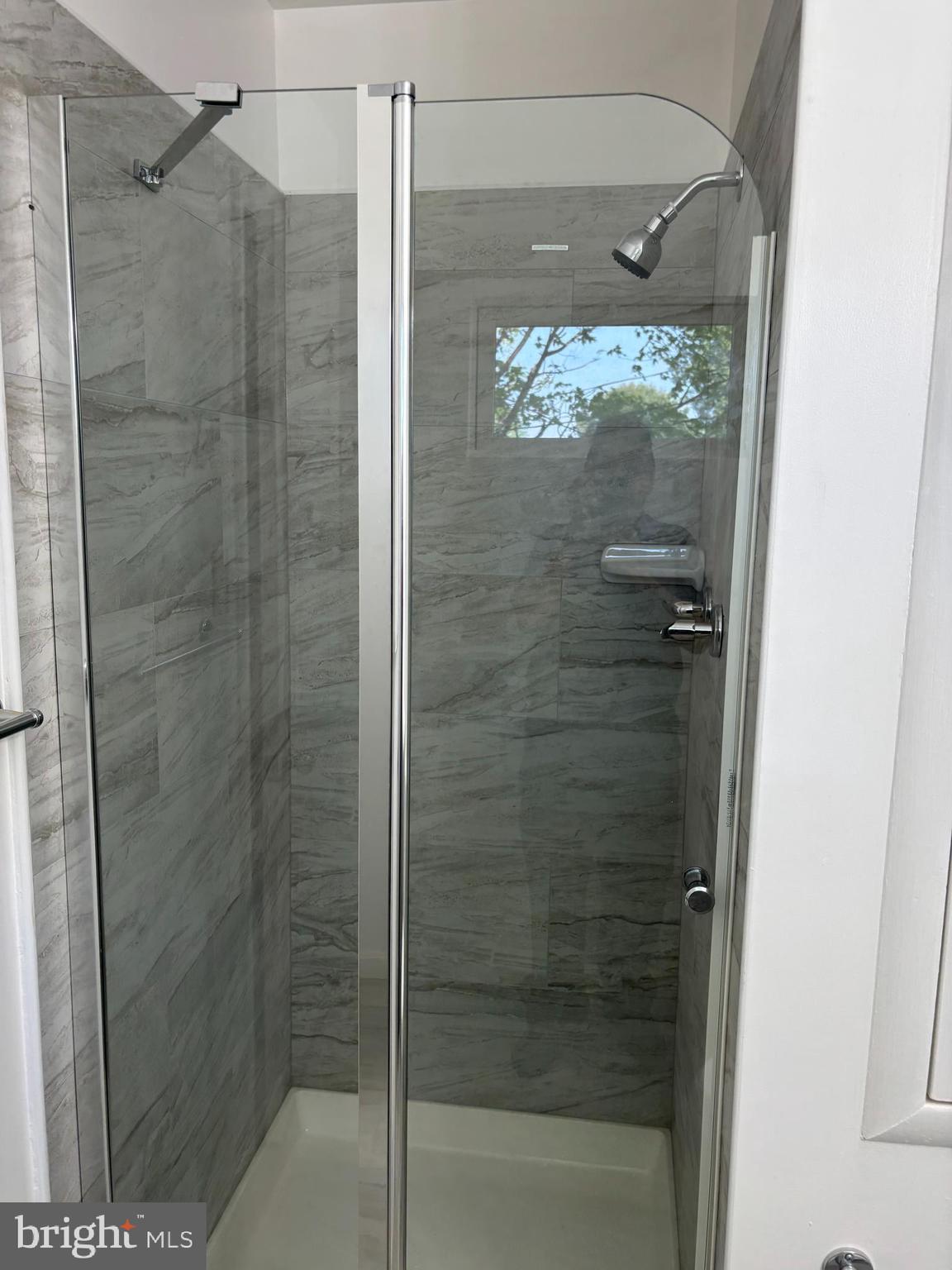 9016 Samoset Road Randallstown, MD 21133 - Photo 30 of 36 a bathroom with a glass shower door