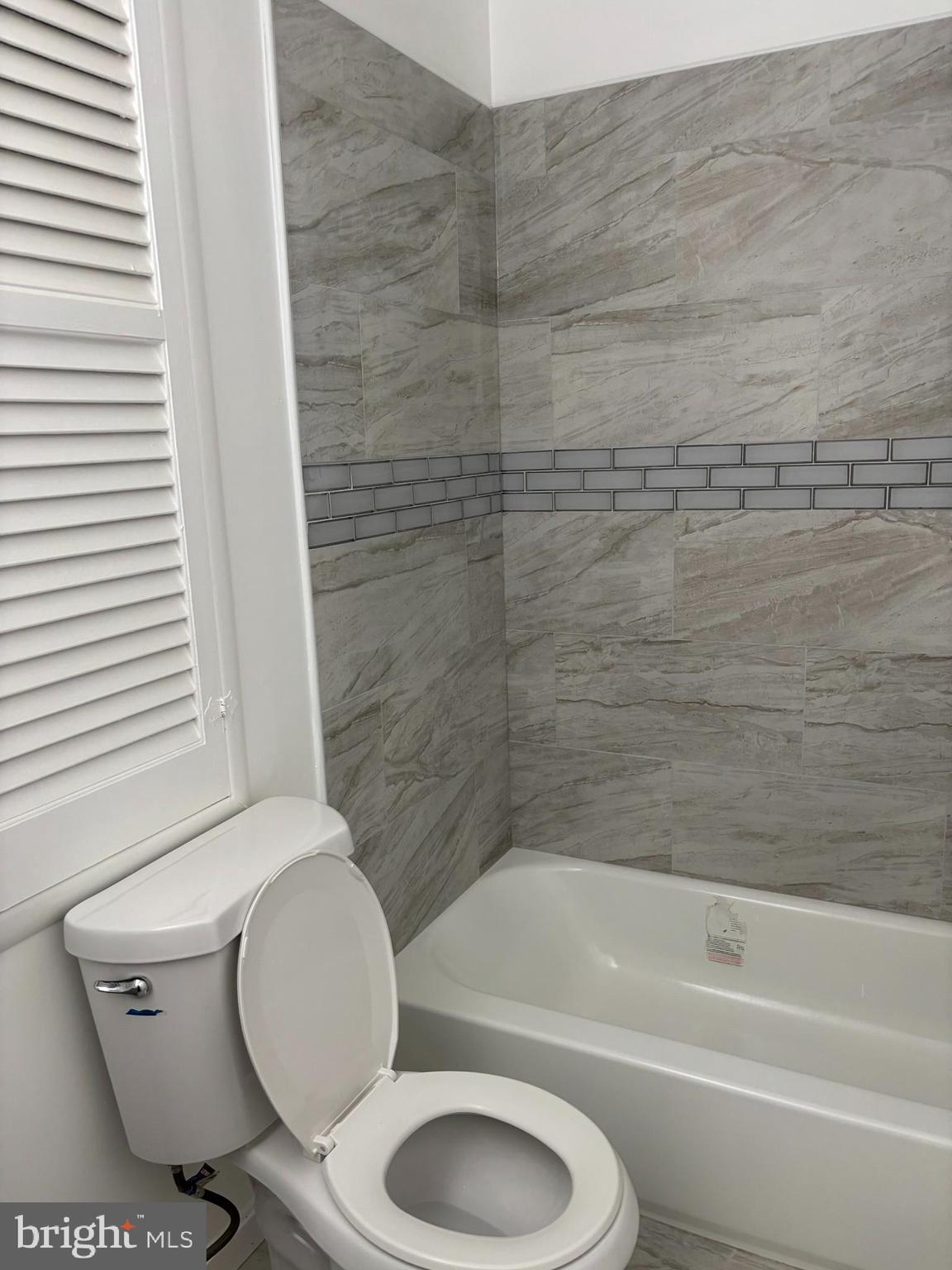 9016 Samoset Road Randallstown, MD 21133 - Photo 34 of 36 a bathroom with a toilet and a bathtub
