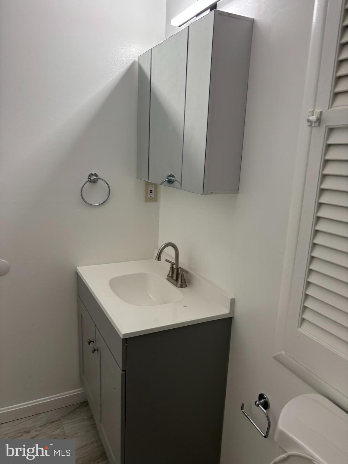 9016 Samoset Road Randallstown, MD 21133 - Photo 35 of 36 a bathroom with a sink toilet and mirror