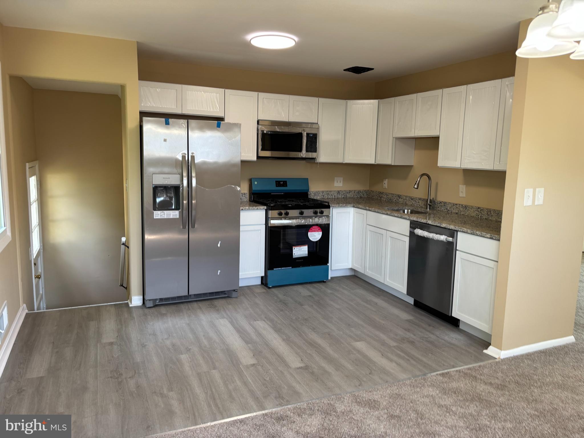 9016 Samoset Road Randallstown, MD 21133 - Photo 5 of 36 a kitchen with stainless steel appliances granite countertop a stove a refrigerator and a sink