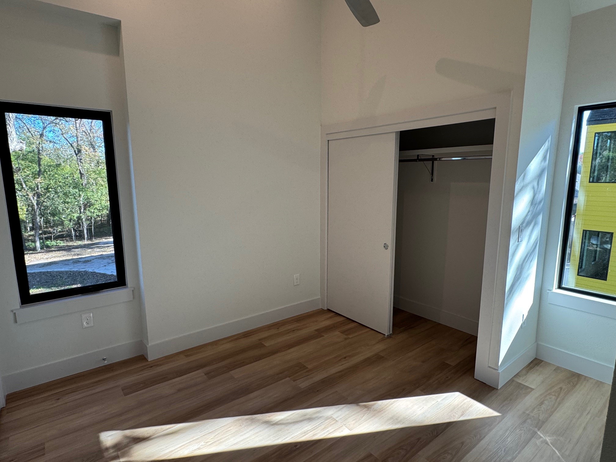 1131 Walton Lane, Unit 4 Austin, TX 78721 - Photo 11 of 13 an empty room with wooden floor and windows