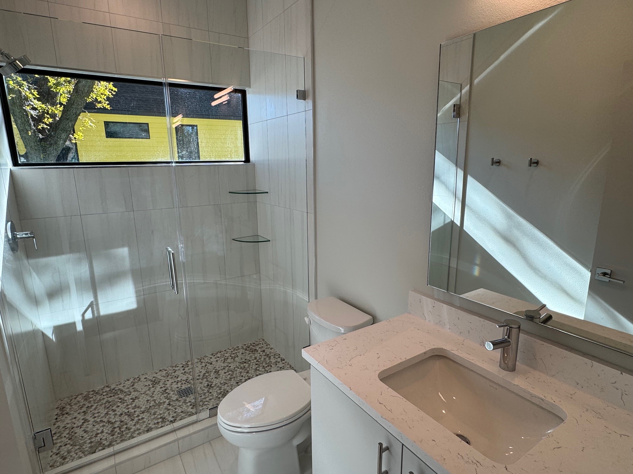 1131 Walton Lane, Unit 4 Austin, TX 78721 - Photo 12 of 13 a bathroom with a sink a toilet and shower