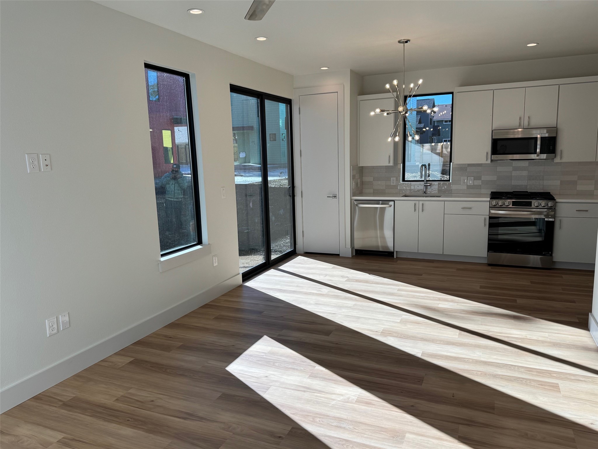 1131 Walton Lane, Unit 4 Austin, TX 78721 - Photo 5 of 13 a kitchen with stainless steel appliances granite countertop a refrigerator and a stove top oven