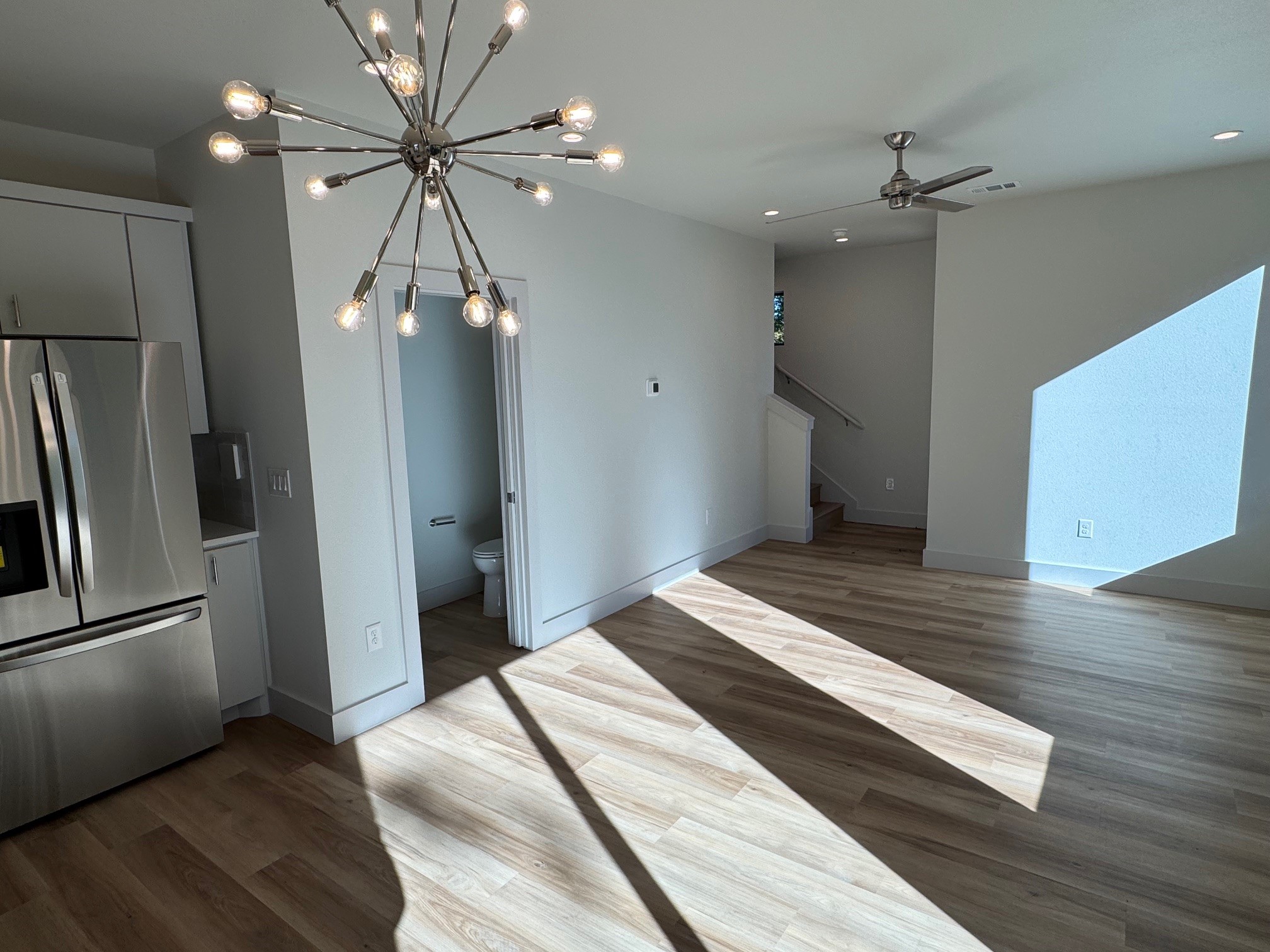 1131 Walton Lane, Unit 4 Austin, TX 78721 - Photo 8 of 13 a bedroom with a bed and a chandelier