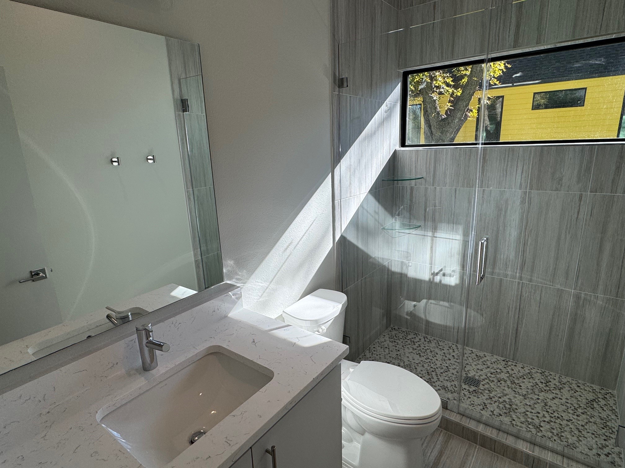 1131 Walton Lane, Unit 4 Austin, TX 78721 - Photo 10 of 13 a bathroom with a sink a toilet and shower