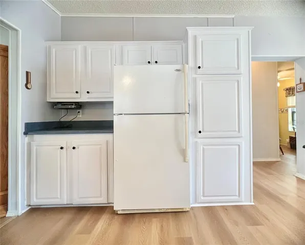 a white refrigerator freezer sitting inside of a kitchen