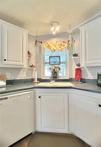 a kitchen with sink and cabinets