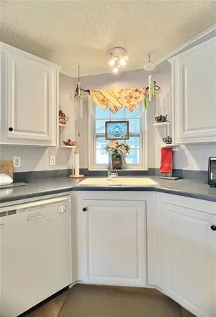 a kitchen with sink and cabinets