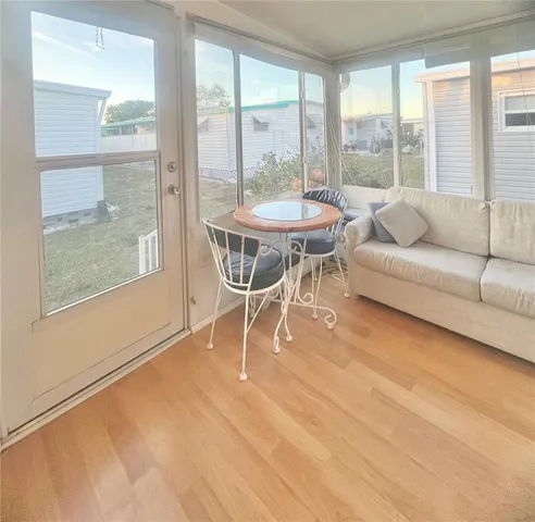 a dining room with furniture and large windows