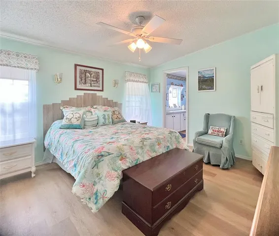 a spacious bedroom with a bed and a chandelier