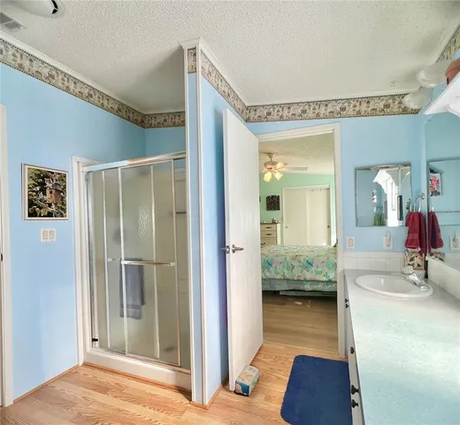 a view of a hallway with bathroom and mirror