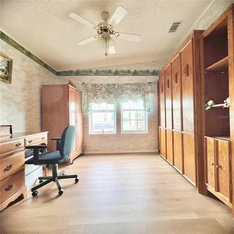 a view of a livingroom with workspace and a window