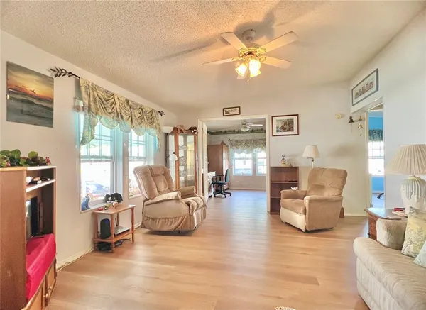 a living room with furniture and large windows