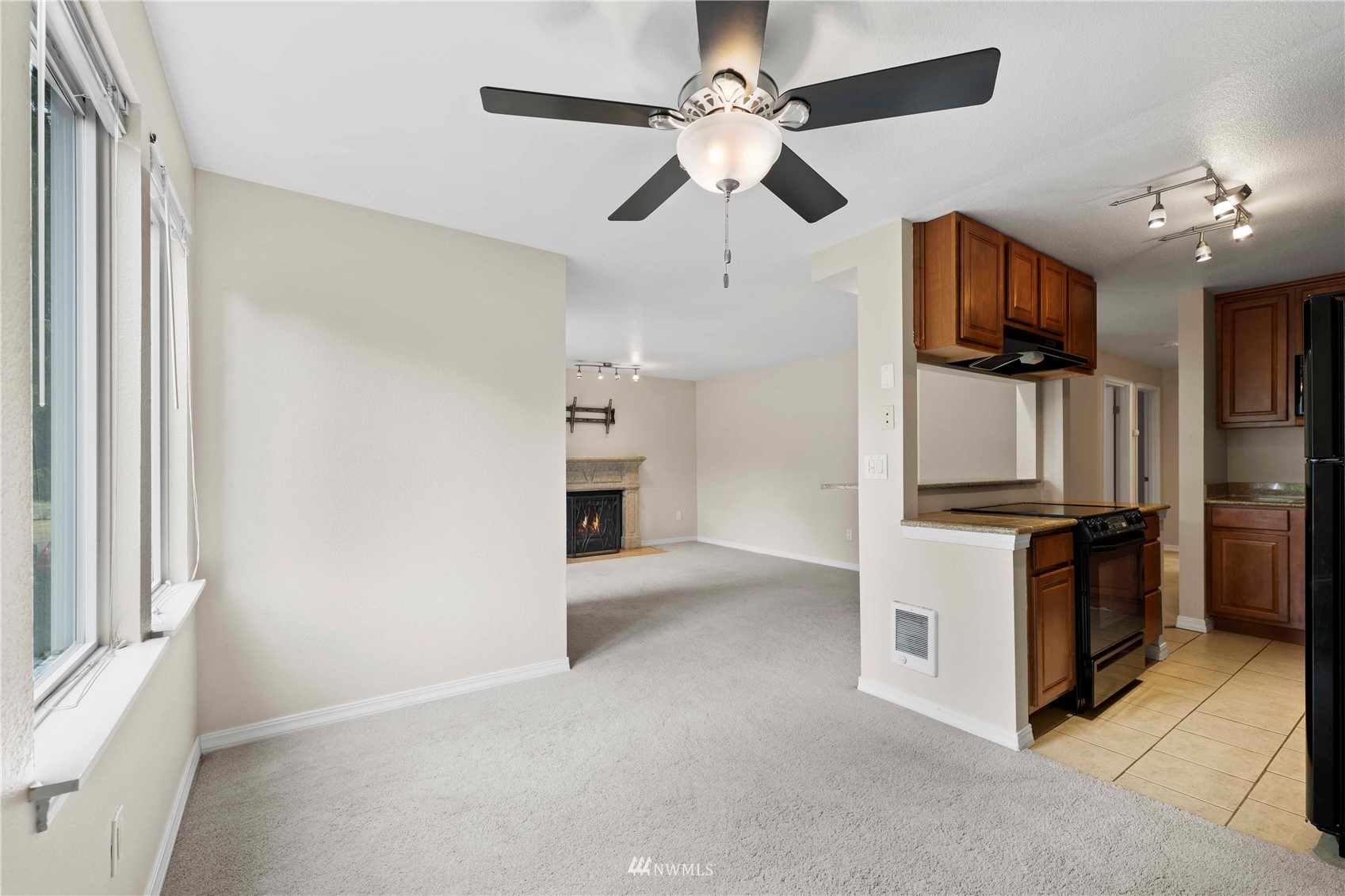 20318 Bothell Everett Highway, Unit A202 Bothell, WA 98012 - Photo 11 of 28 a view of kitchen with stove top oven and refrigerator