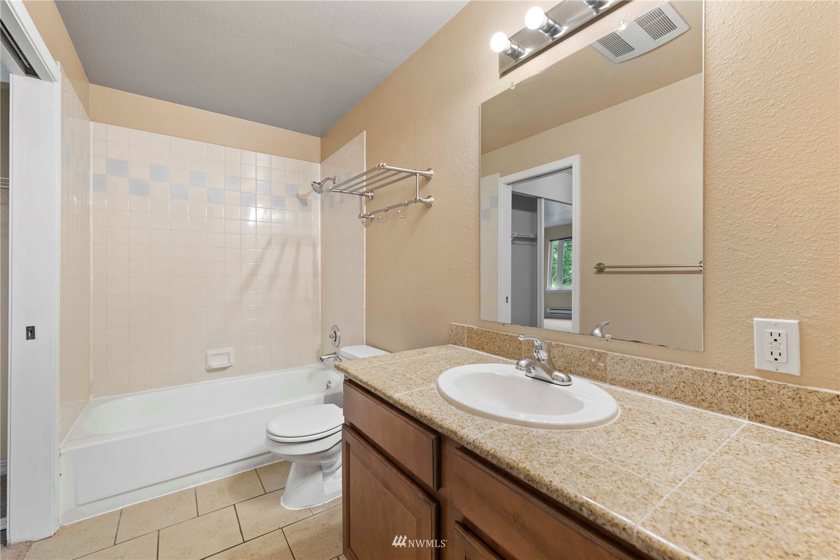 20318 Bothell Everett Highway, Unit A202 Bothell, WA 98012 - Photo 19 of 28 a bathroom with a granite countertop sink toilet and shower