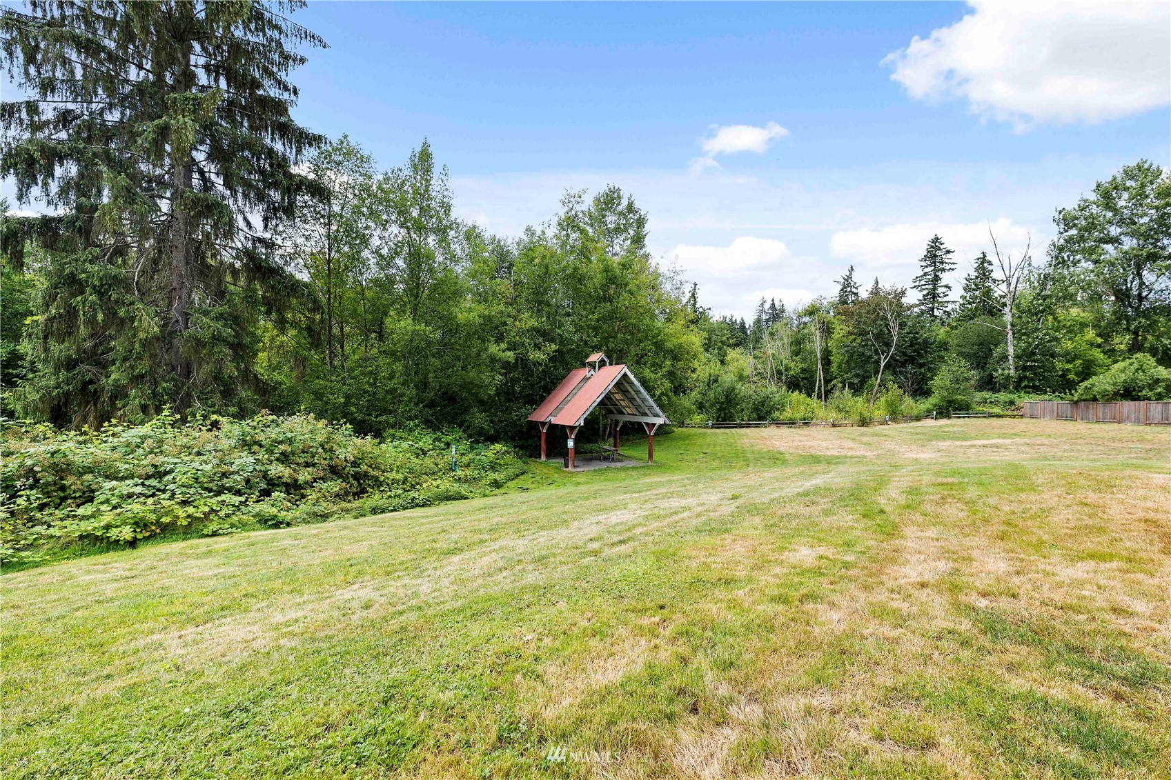 20318 Bothell Everett Highway, Unit A202 Bothell, WA 98012 - Photo 27 of 28 a backyard of a house with lots of green space and plants