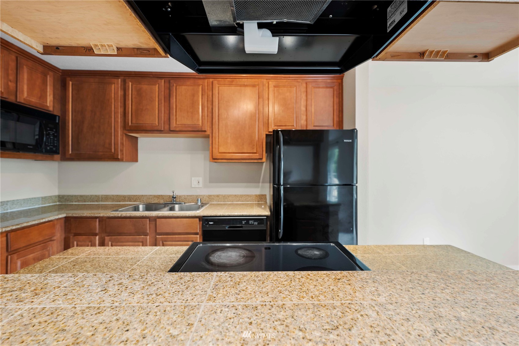 20318 Bothell Everett Highway, Unit A202 Bothell, WA 98012 - Photo 4 of 28 a kitchen with a sink a refrigerator and cabinets
