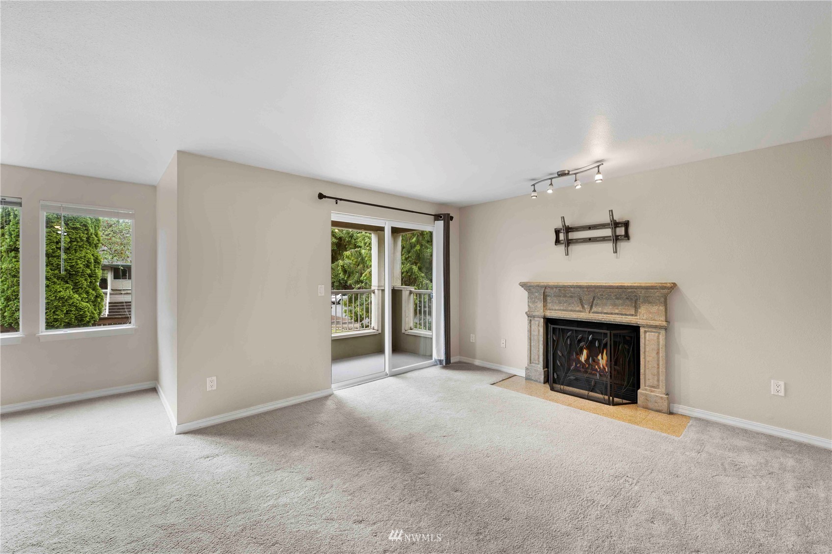 20318 Bothell Everett Highway, Unit A202 Bothell, WA 98012 - Photo 6 of 28 an empty room with windows and fireplace