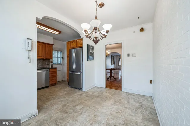 a view of a kitchen with a sink and refrigerator